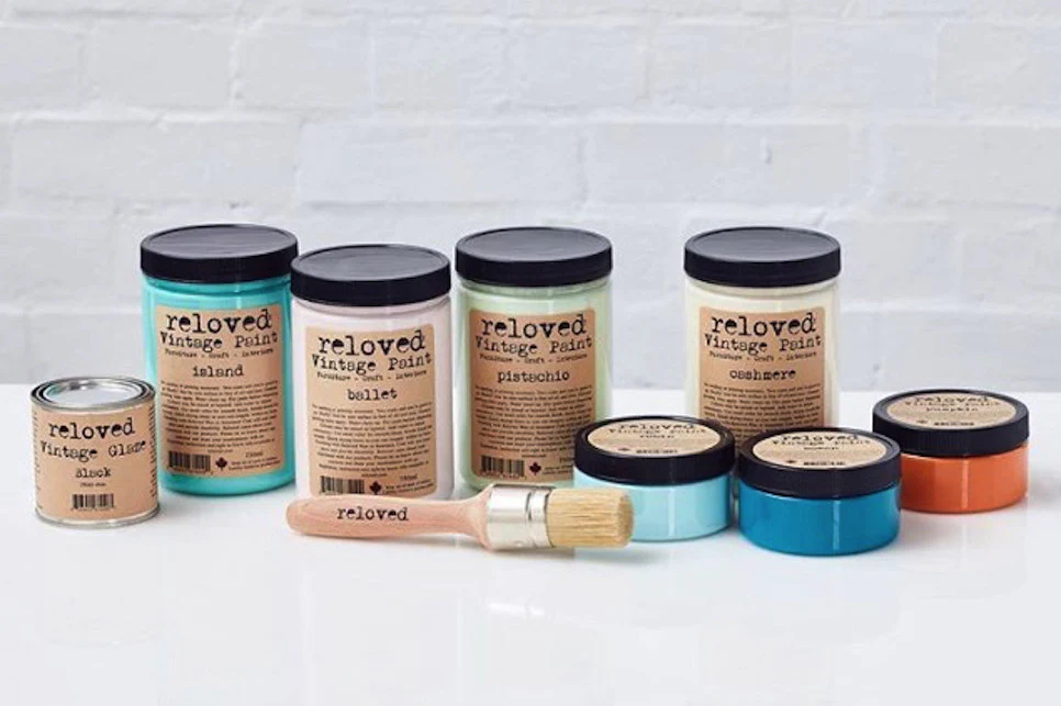 A collection of Reloved Vintage Paint jars in assorted colours with a paint brush