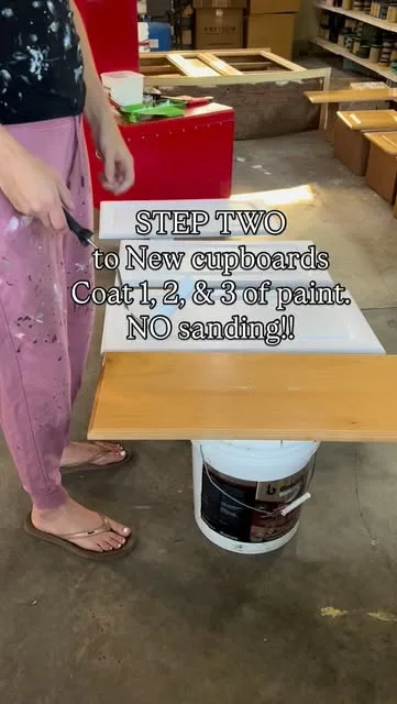 Painting cupboard doors, captioned “Step two – coat 1, 2 & 3 of paint, no sanding!”
